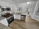 Modern kitchen with stainless steel appliances, granite countertops, and open layout at 2231 Mill Garden Pl, Buford, GA 30519