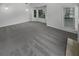 Spacious carpeted living room features large windows, neutral colors, and recessed lighting at 2231 Mill Garden Pl, Buford, GA 30519