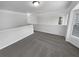 Carpeted loft area with neutral colors and a window for plenty of natural light at 2231 Mill Garden Pl, Buford, GA 30519
