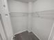 Empty walk-in closet with ample shelving and neutral carpet is move-in ready for maximum storage space at 2231 Mill Garden Pl, Buford, GA 30519