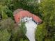 Wide aerial view of sprawling home with tile roof surrounded by lush trees and greenery at 3401 Stillhouse Se Rd, Atlanta, GA 30339