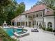 Stunning backyard with pool, spa, outdoor fireplace, and covered patio for elegant entertaining at 3401 Stillhouse Se Rd, Atlanta, GA 30339