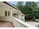 Long view of the tiled balcony with white railing and the manicured backyard of the house at 3401 Stillhouse Se Rd, Atlanta, GA 30339