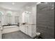 Elegant bathroom with glass shower, soaking tub, double vanity and plenty of natural light at 3401 Stillhouse Se Rd, Atlanta, GA 30339
