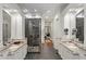 Bright main bathroom with double vanity, glass shower with pebble floor, and neutral decor at 3401 Stillhouse Se Rd, Atlanta, GA 30339