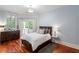 This primary bedroom features a private balcony, hardwood floors, and a decorative light fixture at 3401 Stillhouse Se Rd, Atlanta, GA 30339