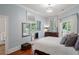 This bedroom has multiple mirrors, hardwood floors, and a balcony at 3401 Stillhouse Se Rd, Atlanta, GA 30339