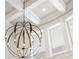 Close-up of a large chandelier and coffered ceilings at 3401 Stillhouse Se Rd, Atlanta, GA 30339