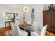 Elegant dining room with glass table, modern chandelier, and hardwood floors at 3401 Stillhouse Se Rd, Atlanta, GA 30339