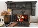 A detailed black marble fireplace with burning fire at 3401 Stillhouse Se Rd, Atlanta, GA 30339