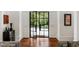 Elegant foyer featuring a black steel and glass front door, wood floors and detailed trim at 3401 Stillhouse Se Rd, Atlanta, GA 30339