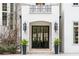 Elegant front entrance with black steel glass door and manicured landscape at 3401 Stillhouse Se Rd, Atlanta, GA 30339