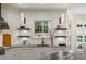 Bright kitchen with white cabinets, stone countertops, a large window, and stainless steel appliances at 3401 Stillhouse Se Rd, Atlanta, GA 30339