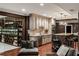 Kitchenette area with stainless steel appliances, custom cabinetry, and adjacent climate-controlled wine cellar at 3401 Stillhouse Se Rd, Atlanta, GA 30339