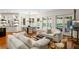 Bright living room with hardwood floors, white sofas, and large windows overlooking the pool at 3401 Stillhouse Se Rd, Atlanta, GA 30339