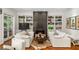 Cozy living room with fireplace, built-in shelving, and white sofas at 3401 Stillhouse Se Rd, Atlanta, GA 30339