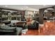 Spacious living area with a wine cellar, kitchenette, and comfortable seating on dark wood floors at 3401 Stillhouse Se Rd, Atlanta, GA 30339