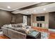 Comfortable living room with a large sectional sofa, built-in media center, and hardwood flooring at 3401 Stillhouse Se Rd, Atlanta, GA 30339