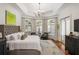 Bright main bedroom features trey ceiling, bay window, hardwood floors and neutral decor at 3401 Stillhouse Se Rd, Atlanta, GA 30339
