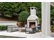 Inviting outdoor patio featuring a stone fireplace and comfortable seating area for relaxing and entertaining at 3401 Stillhouse Se Rd, Atlanta, GA 30339