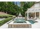 Beautiful pool and spa surrounded by lush landscaping and an outdoor fireplace at 3401 Stillhouse Se Rd, Atlanta, GA 30339