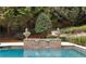 Close-up of the pool's water feature, adding an element of elegance to the landscape at 3401 Stillhouse Se Rd, Atlanta, GA 30339