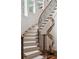 Elegant staircase with carpeted treads, wood handrail and iron balusters and hardwood floor landing at 3401 Stillhouse Se Rd, Atlanta, GA 30339