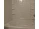 Bathroom showcasing a clean white bathtub with tile surround and modern fixtures at 515 Brady Dr, Villa Rica, GA 30180