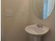 Cozy bathroom features a pedestal sink with a large mirror and modern fixtures at 515 Brady Dr, Villa Rica, GA 30180