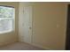 This bedroom has neutral paint, carpet, one window, an overhead light, and a door to another room at 515 Brady Dr, Villa Rica, GA 30180