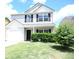 Charming two-story home with a well-manicured lawn, an attached garage, and inviting front entrance at 515 Brady Dr, Villa Rica, GA 30180