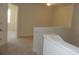 This is a carpeted hallway with neutral paint and stairs to access the first floor at 515 Brady Dr, Villa Rica, GA 30180