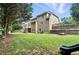 The back yard of a home with a stone wall, a patio, and a slide at 5807 Brookstone Nw Walk, Acworth, GA 30101