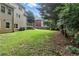 The back yard of a home with a large green lawn and a wooded area at 5807 Brookstone Nw Walk, Acworth, GA 30101
