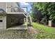 Backyard with brick patio, deck with stairs, and partial view of the house exterior at 5807 Brookstone Nw Walk, Acworth, GA 30101