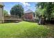 Expansive backyard features a playset, stone retaining wall, and lush green lawn at 5807 Brookstone Nw Walk, Acworth, GA 30101