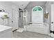 Bathroom featuring a shower and tub combination, shiplap walls, and a large window at 5807 Brookstone Nw Walk, Acworth, GA 30101