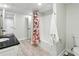 A bathroom with tile floors, a black granite countertop, and a white shower with a colorful shower curtain at 5807 Brookstone Nw Walk, Acworth, GA 30101