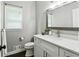 Bathroom featuring a vanity with white marble countertop, dark wood framed mirror, and neutral paint at 5807 Brookstone Nw Walk, Acworth, GA 30101