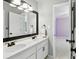 Bathroom with dual vanities, modern fixtures, and a view into the bedroom at 5807 Brookstone Nw Walk, Acworth, GA 30101