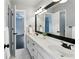 Bathroom with double sinks, large mirror, white cabinets, and black hardware at 5807 Brookstone Nw Walk, Acworth, GA 30101