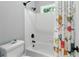 Bathroom featuring a tub, white tile, and a vibrant shower curtain at 5807 Brookstone Nw Walk, Acworth, GA 30101