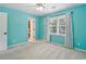 Bright bedroom with light blue walls, a ceiling fan, a window with blinds, and neutral carpet at 5807 Brookstone Nw Walk, Acworth, GA 30101