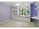 Bedroom with a built-in bookshelf, desk, window seat, and purple paint at 5807 Brookstone Nw Walk, Acworth, GA 30101