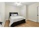 A bedroom with white walls, a queen bed with a dark wood frame, and a ceiling fan at 5807 Brookstone Nw Walk, Acworth, GA 30101