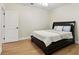 A bedroom with white walls, a queen bed with a dark wood frame and light blue pillows at 5807 Brookstone Nw Walk, Acworth, GA 30101