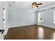 This bedroom has hardwood floors, a ceiling fan, and white trim at 5807 Brookstone Nw Walk, Acworth, GA 30101
