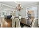 Dining room with chandelier, hardwood floors, and open layout to kitchen and stairway at 5807 Brookstone Nw Walk, Acworth, GA 30101
