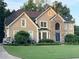 Charming two-story home boasting stone accents, a manicured lawn, and mature trees at 5807 Brookstone Nw Walk, Acworth, GA 30101