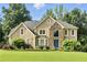 Stunning two-story home featuring stone accents, a manicured lawn, and lush landscaping at 5807 Brookstone Nw Walk, Acworth, GA 30101
